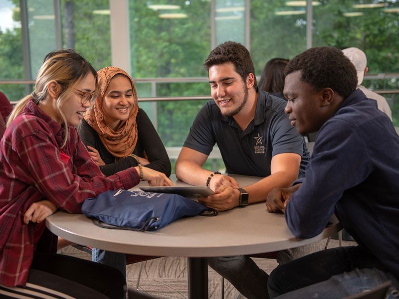 Students sitting at a round table.