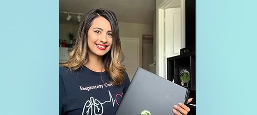 Female holding a laptop
